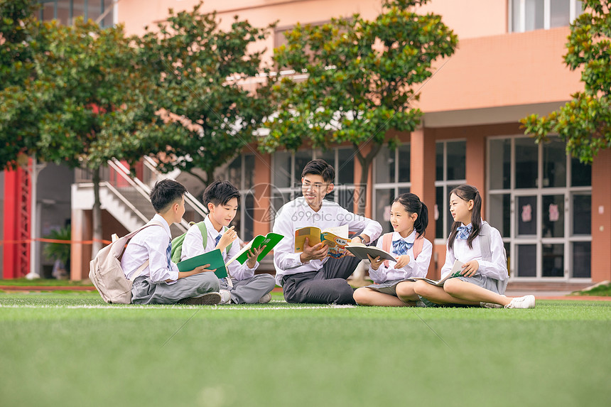 老师和学生坐在操场上讨论图片