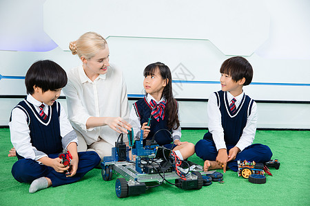 外教和学生外教和小朋友一起做机器人背景
