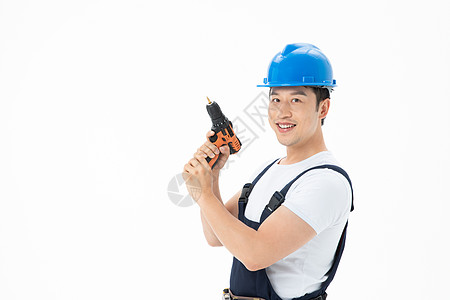 放着枪的桌面维修工人拿着电钻枪背景