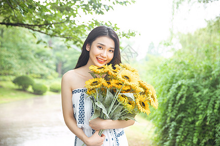 向日葵花束拿着向日葵的少女背景