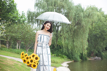 雨中的女孩雨中撑伞提花的少女背景