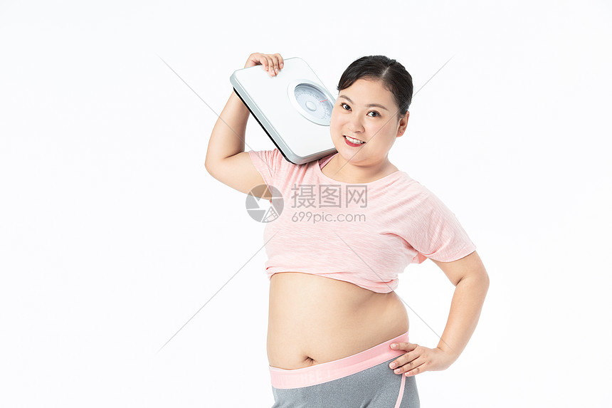 胖女孩手拿体重秤图片