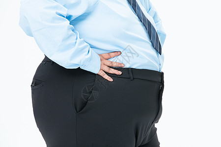 肥胖商务男性摸着肚子图片