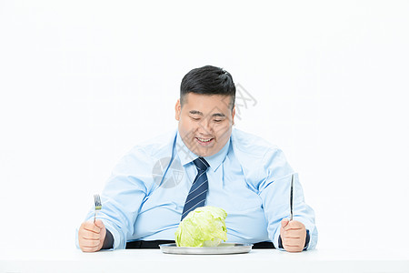 肥胖商务男性吃蔬菜背景
