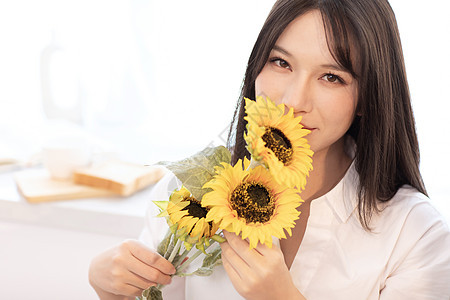 居家女性拿着向日葵图片