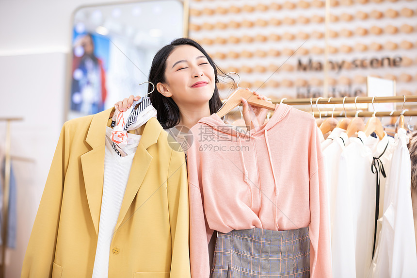 年轻美女商场购物挑选衣服图片