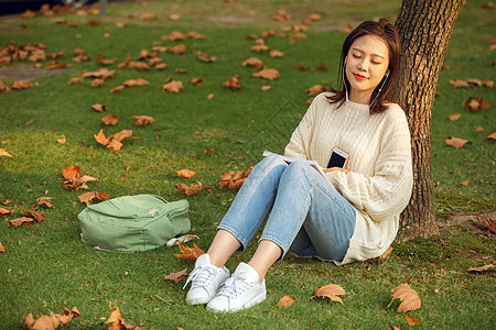 甜美女生户外听音乐书包高清图片素材