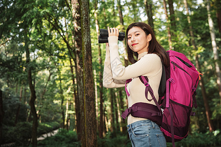 登山女性拿着望远镜图片