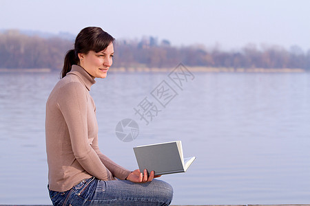 坐在户外看书的女人图片