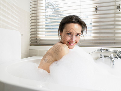 女人在浴缸里洗澡背景图片