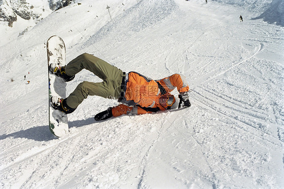 滑雪的男子在雪地里滚动图片