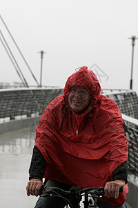 穿雨衣骑自行车的老人图片