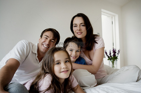 一家人坐在床上的照片图片