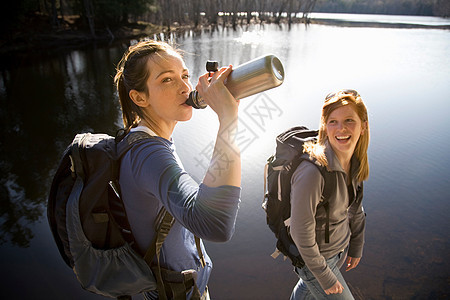 两个女人在湖边共享水图片