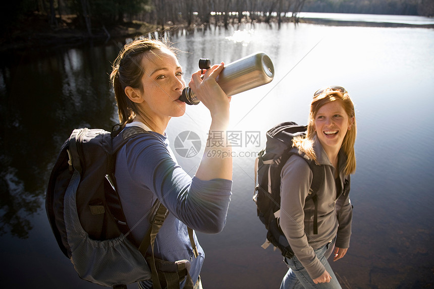 两个女人在湖边共享水图片