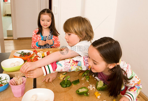 两个男孩和女孩在做饭图片