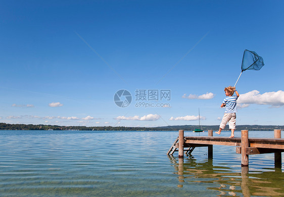 男孩在湖中捕鱼图片