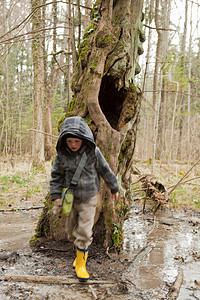 在森林里泥泞中晃荡的男孩图片
