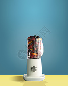 果汁机中的新鲜浆果和柑橘水果背景图片