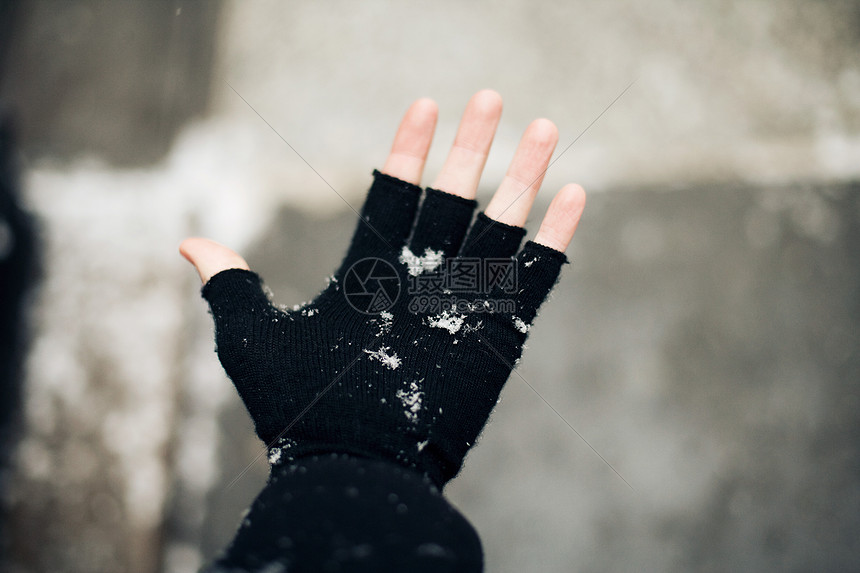 在雪地里戴无指手套的人图片