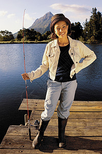 在湖边钓鱼的年轻女孩图片