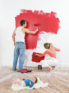 一对夫妇在粉刷墙壁图片