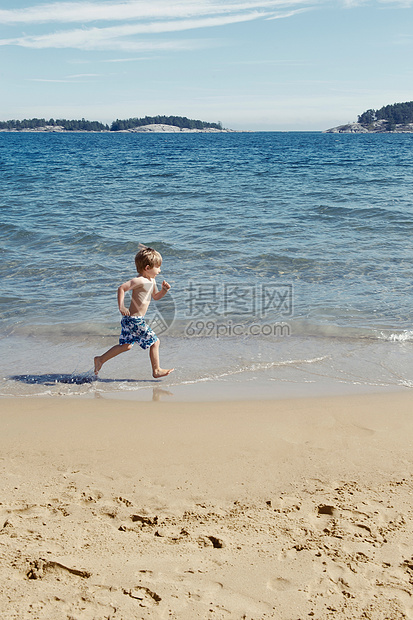 海滩上奔跑的男孩图片