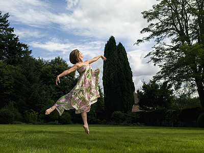在花园里跳舞的年轻女子图片