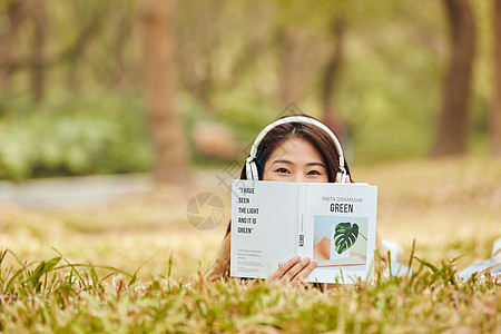 年轻女性户外听音乐看书图片