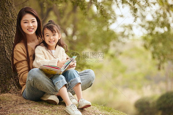 温馨母女坐在树下读书图片