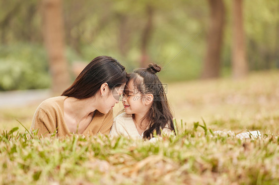 温馨母女趴在草地上玩耍图片