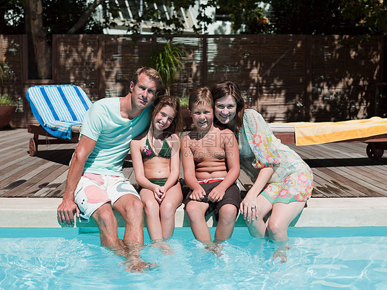 一家人坐在游泳池边上图片