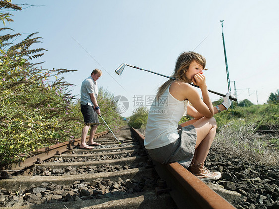 铁路轨道上的高尔夫球手图片