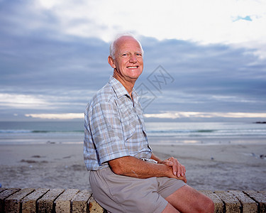坐在海边的成熟男人图片