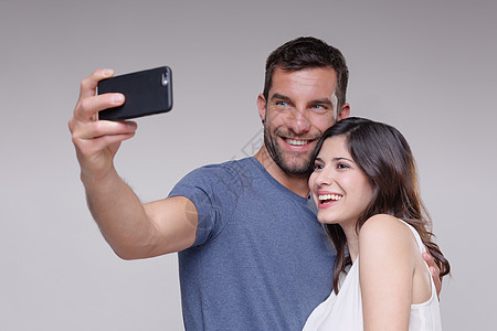 异性恋伴侣使用智能手机自拍图片