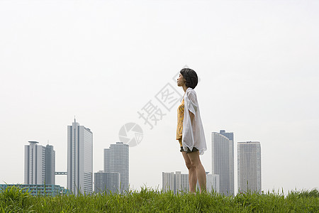 城市天际线前的年轻女子图片