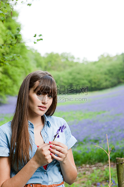 有蓝铃花的年轻女子图片