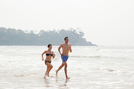 一对夫妇在海里奔跑图片