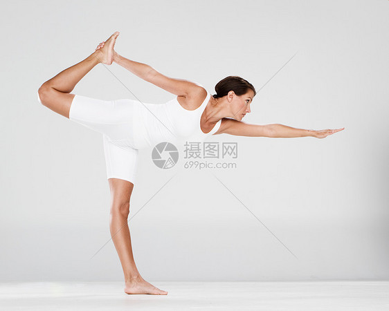在白色工作室练习瑜伽的女人图片