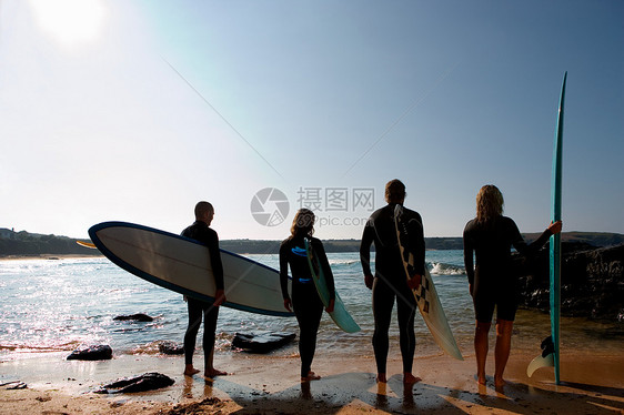 四个人拿着冲浪板准备冲浪图片