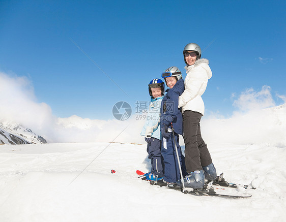 女人和两个穿滑雪板的男孩图片