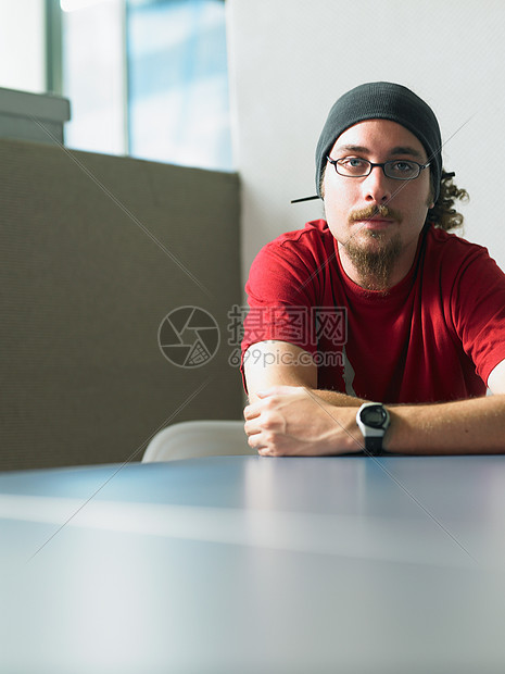 坐在书桌旁的年轻人肖像图片