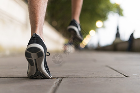 穿着运动鞋在人行道上跑步的年轻男性跑步者图片