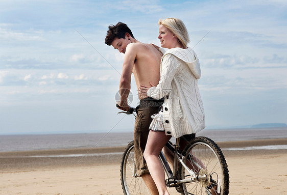 在海滩上骑自行车的夫妇图片