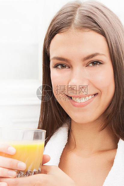 微笑的女人在喝橙汁图片