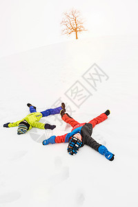两个男孩躺在雪地里图片