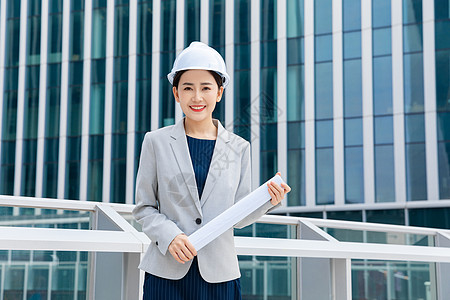 女工人女性建筑工程师拿图纸背景