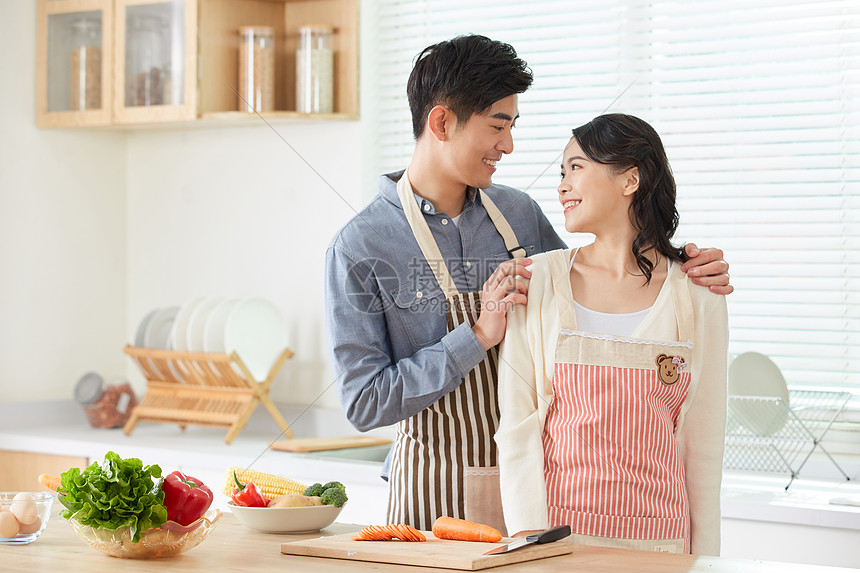 年轻夫妻在厨房一起备菜图片