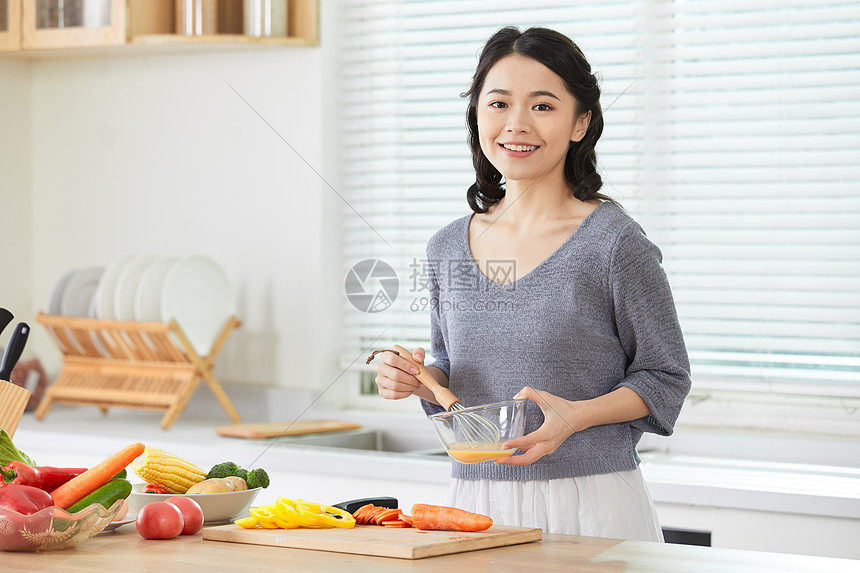 年轻女性在厨房打蛋图片