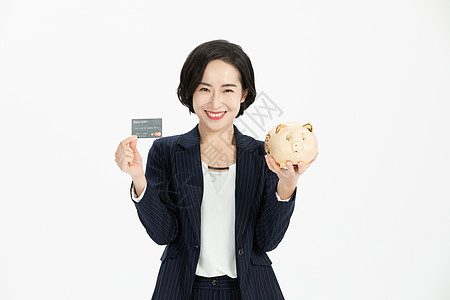 商务女性拿储蓄罐投资理财图片